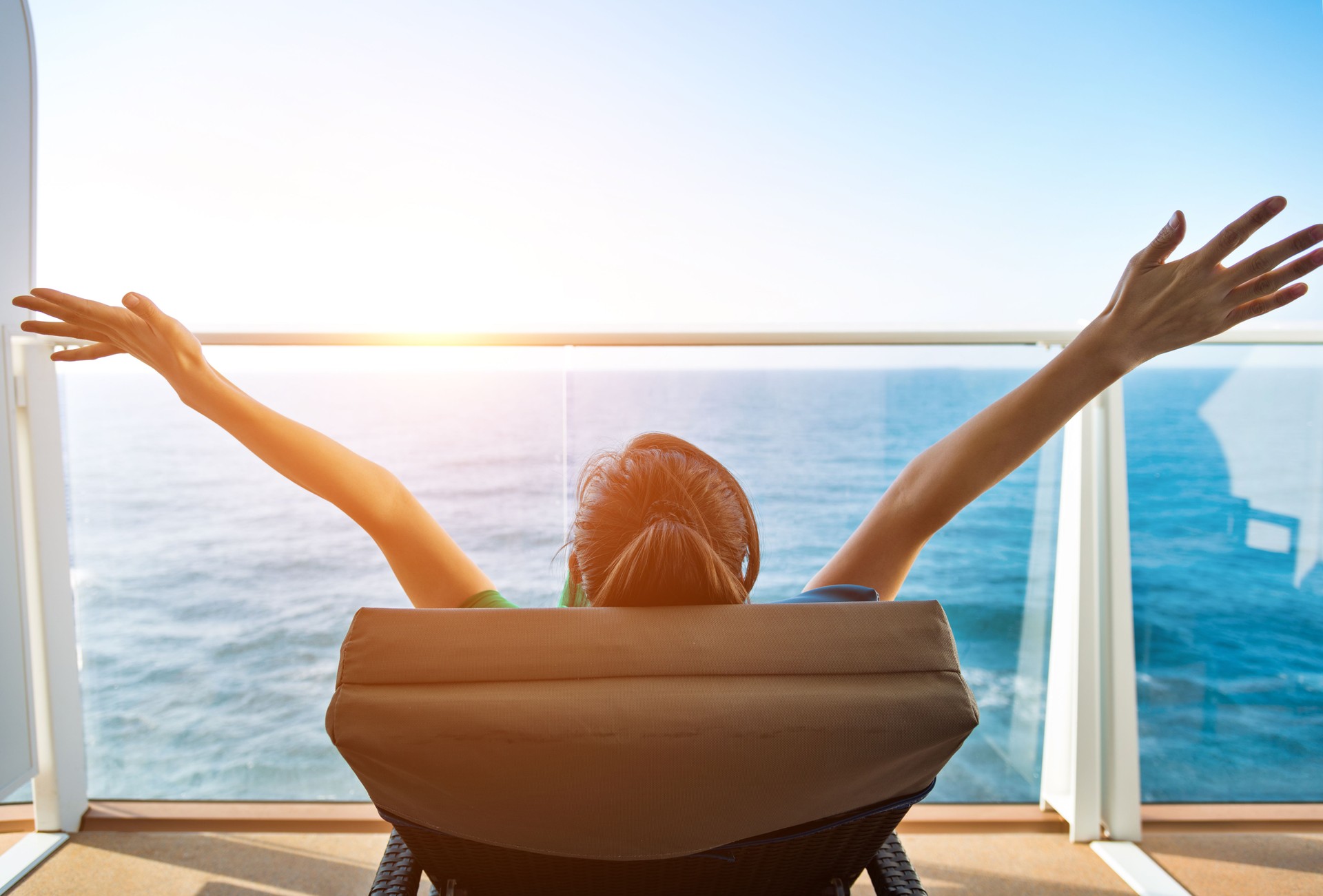 Cheering woman open arms on cruise